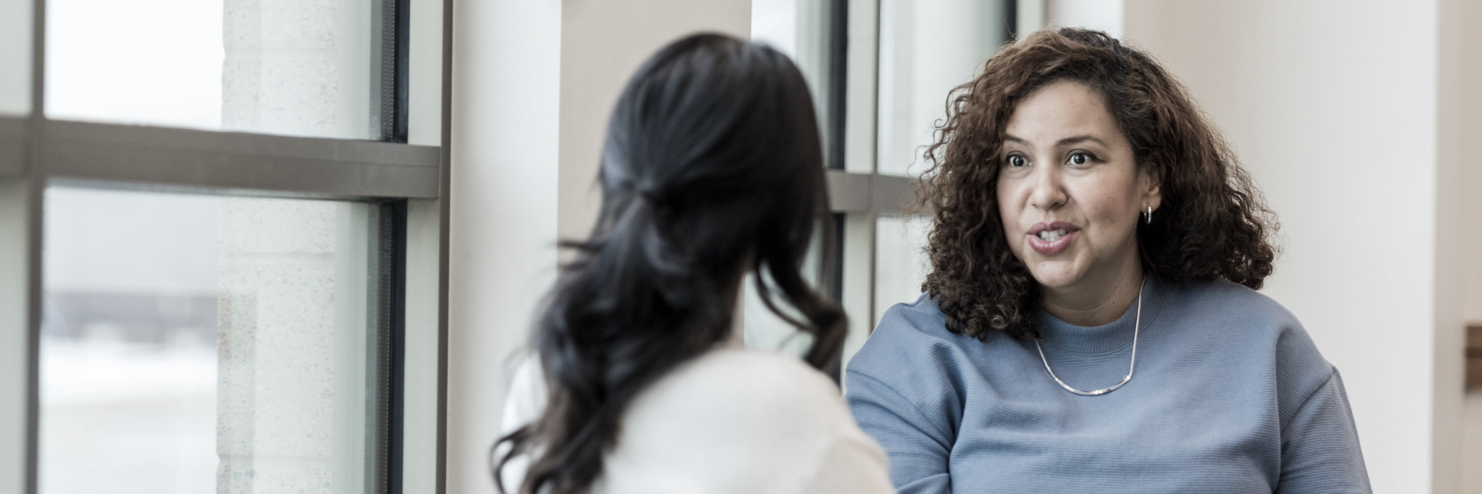 A woman meeting with her case manager about outpatient marijuana/cannabis addiction treatment at Pillars Health Group.