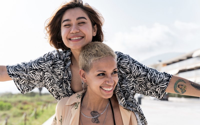 two women outdoors enjoying a sunny day together
