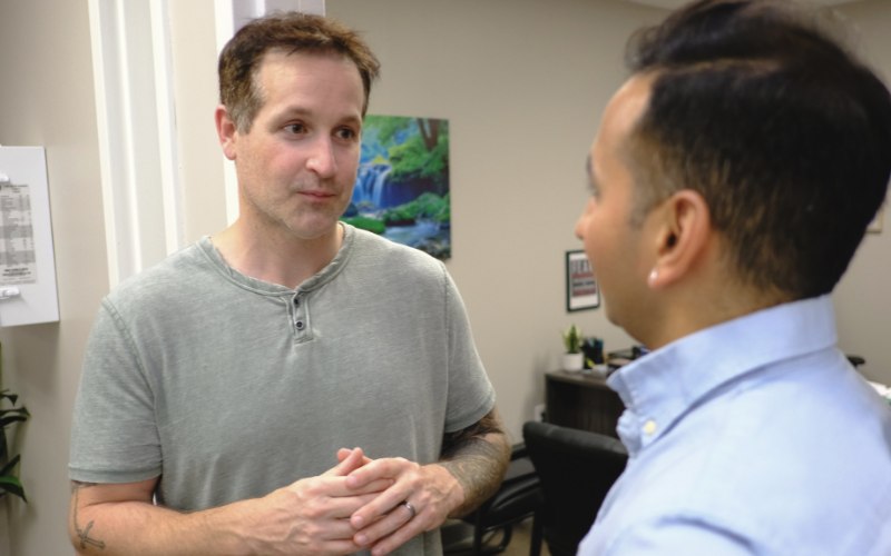a young Indian man listens to his therapist at Pillars. Health Group