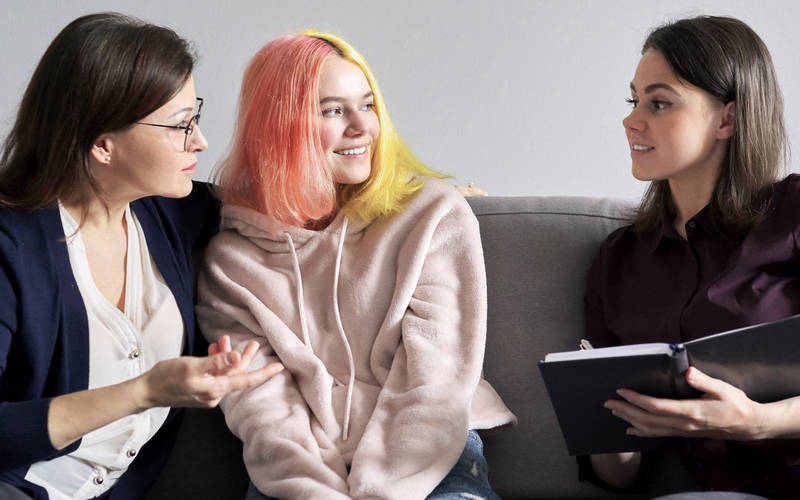A young woman in a family therapy session for teen OCD treatment at Pillars Health Group in Concord, MA.