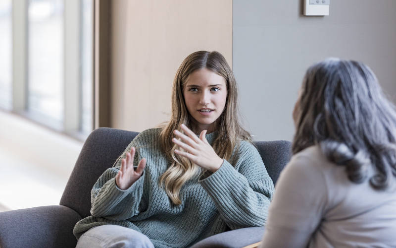 A young woman in an individual therapy session for addiction and mental health treatment in Pepperell, Massachusetts.
