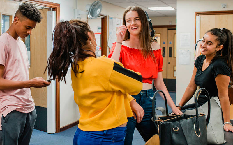 A group of teens learning how teen group therapy can help adolescents feel less alone.