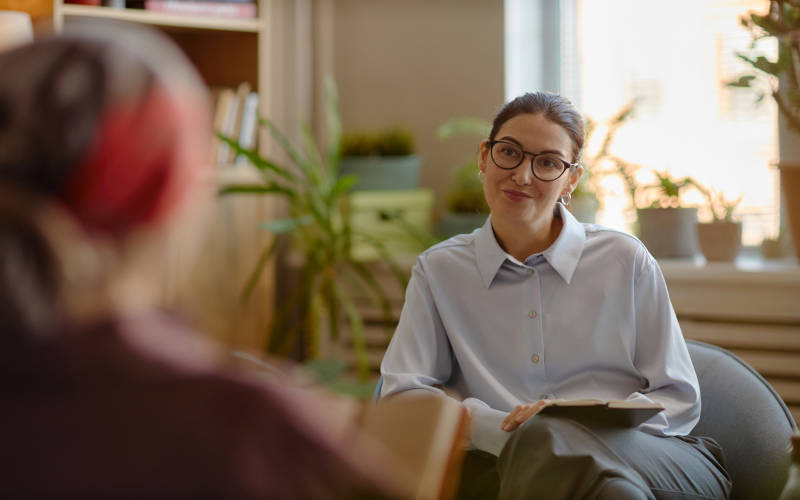 A woman learning about the differences between inpatient, outpatient, and intensive outpatient programs.