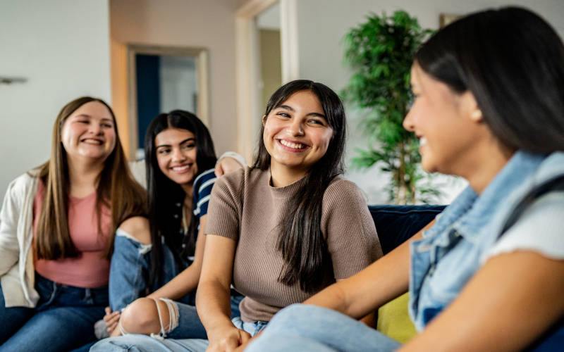 A group of teens happily spending time with each other, proving that peer connection matters in teen mental health treatment.