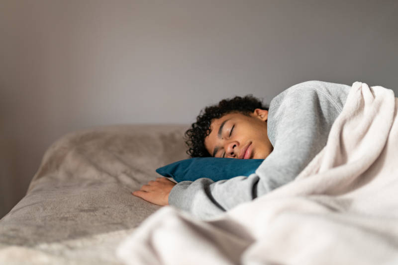 A teen sleeping, showing the importance of teen sleep for emotional wellness.