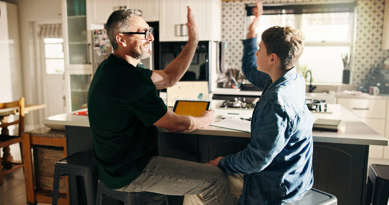 A father helping his son sign up for mental health treatment.